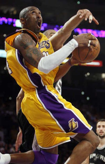
Los Angeles' Kobe Bryant drives to the basket against Ime Udoka's defense. Associated Press
 (Associated Press / The Spokesman-Review)