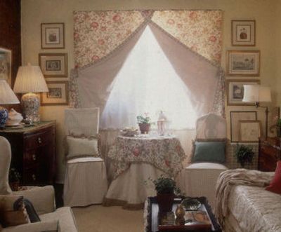 
Small-scaled traditional furniture and art works on the walls add visual interest to this studio apartment room decorated by Cynthia Edmunds of New York. The room also features double-sided curtains with a floral pattern on one side, checks on the other. The sofa cover is reversible, too. By night, that sofa is a single bed. 
 (Associated Press / The Spokesman-Review)