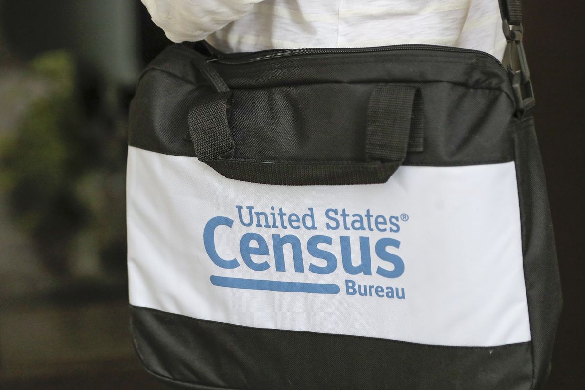 A briefcase of a census taker is seen as she knocks on the door of a residence Tuesday, Aug. 11, 2020, in Winter Park, Fla. A half-million census takers head out en mass this week to knock on the doors of households that haven