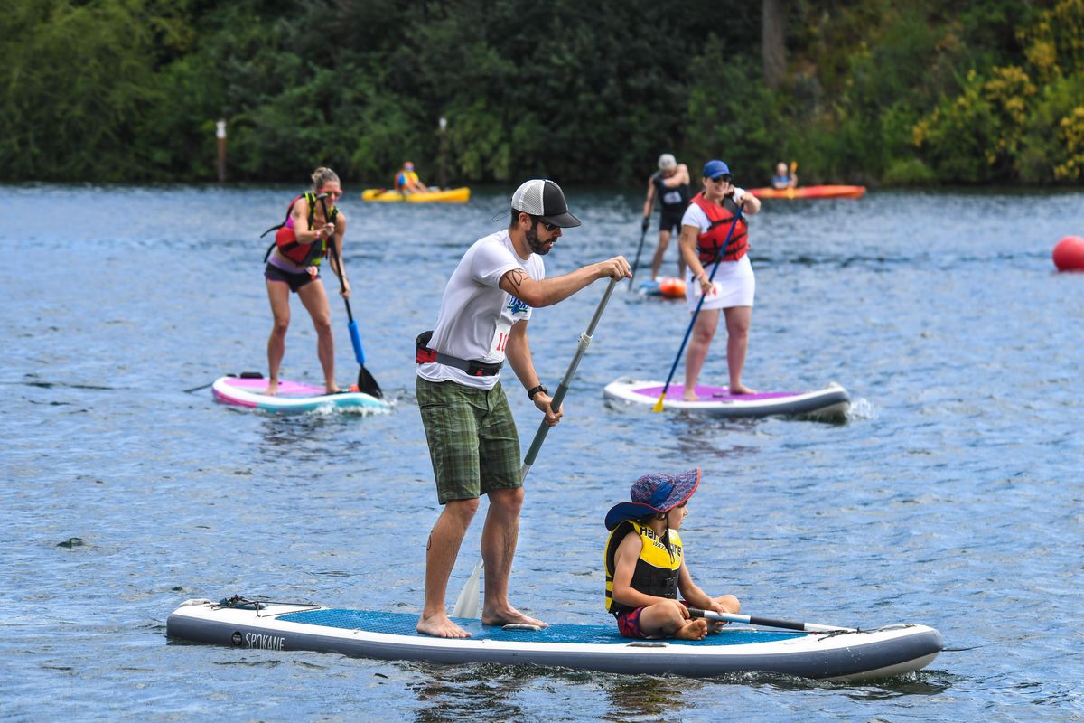 Ryan West, 37, and his son, Jack, 8, team up to paddle during the Spokatopia SUP Cup recreation division race July 14 at Boulder Beach. (Dan Pelle / The Spokesman-Review)