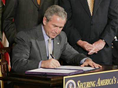 
President Bush signs an appropriations bill in a White House ceremony in October. Without receiving much public notice, Bush also frequently issues bill-signing statements that may revise or put his spin on the legislation being enacted. 
 (Associated Press / The Spokesman-Review)