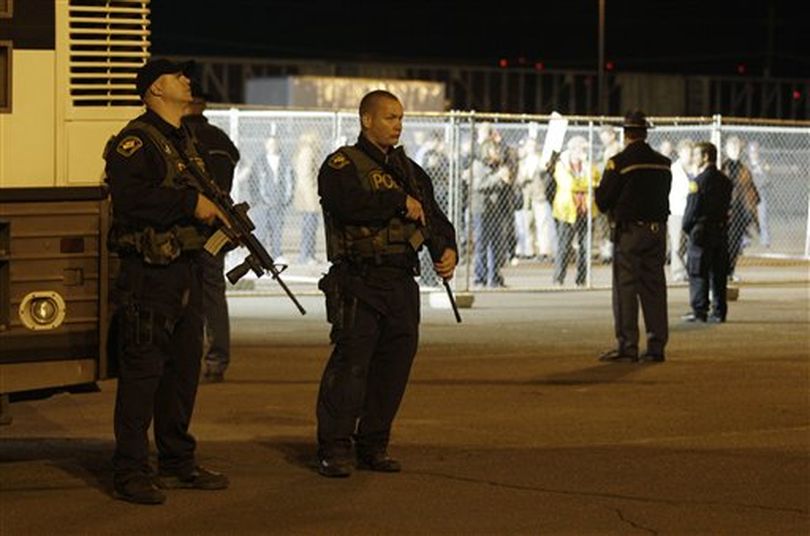 Armed Dept. of Corrections police officers stand watch near a fenced area for death penalty protestors outside the Washington State Penitentiary, Thursday, Sept. 9, 2010, in Walla Walla, Wash. Cal Coburn Brown is scheduled to be executed after midnight for the 1991 murder of Seattle-area woman.  (Ted Warren / (AP Photo/Ted S. Warren))