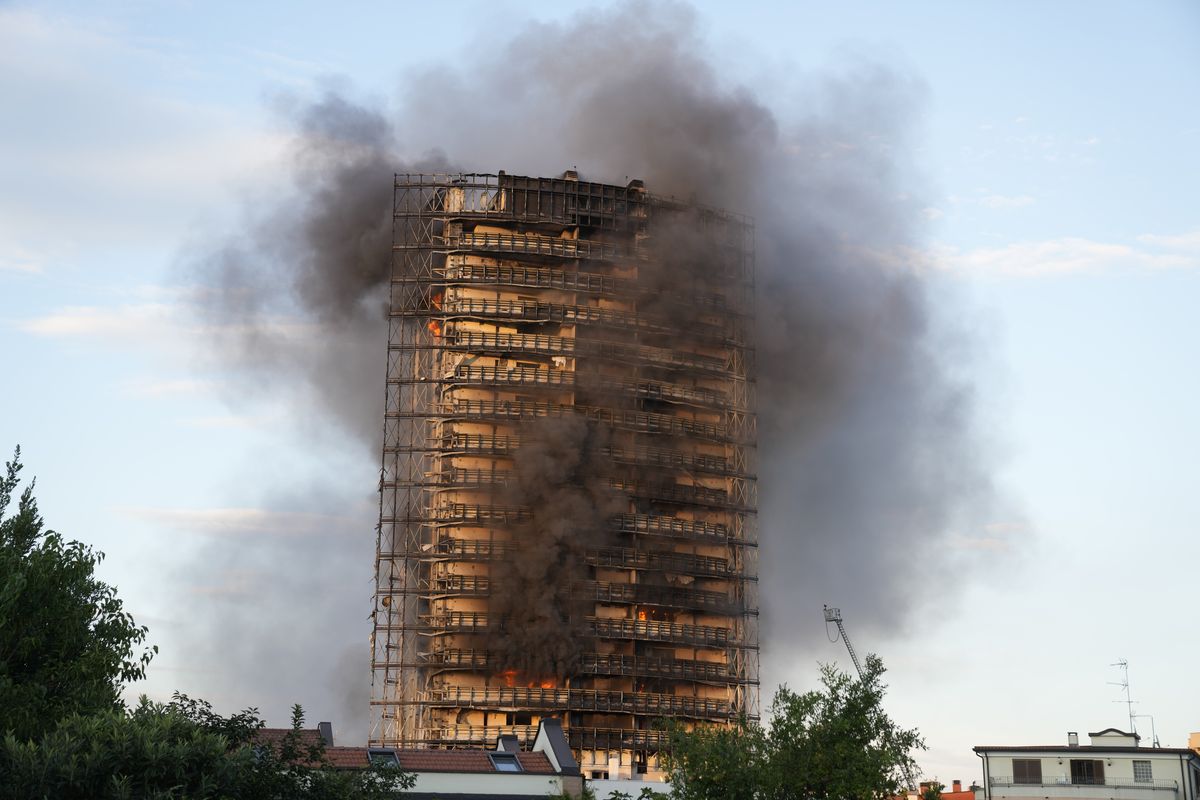 Smoke billows from a building in Milan, Italy, Sunday. Firefighters were battling a blaze on Sunday that spread rapidly through a recently restructured 200-foot-high, 20-story residential building in Milan. There were no immediate reports of injuries or deaths.  (Luca Bruno)