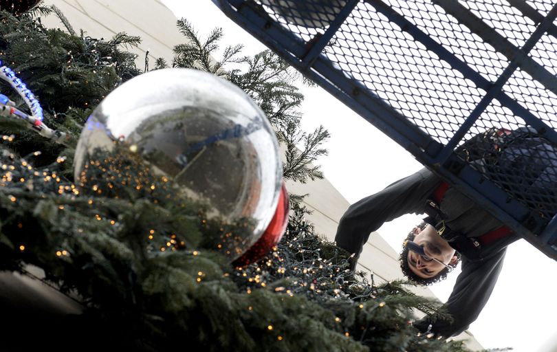 Kyle Olivier, engineer for the Coeur d'Alene Resort worked on the holiday wreath on Tuesday, November 24, 2009 in preparation for the downtown parade and fireworks show on Friday.The wreath, a tradition since the remodeled Resort opened in 1986, weighs almost a ton. (Kathy Plonka)