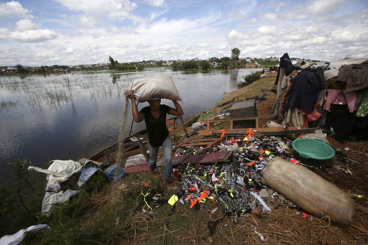 FILE - A man caries belongings from his house destroyed by tropical storm Ana in Antananarivo, Madagascar, Jan. 26, 2022. Extreme rainfall in Africa