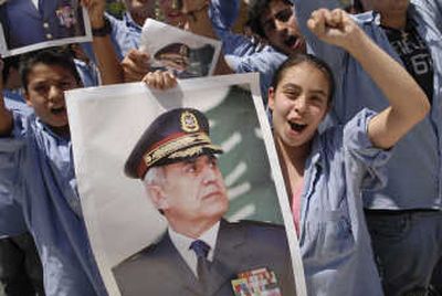 
Children carry pictures of army Gen. Michel Suleiman as they celebrate Wednesday in his hometown of Aamchit,  Lebanon. Associated Press
 (Associated Press / The Spokesman-Review)