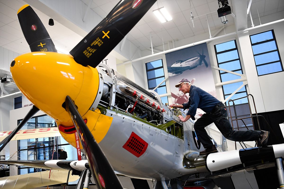 Ben Olson, director of maintenance at the Historic Flight Foundation, removes a battery charger from a P-51B Mustang on Thursday at Felts Field.  (Tyler Tjomsland/THE SPOKESMAN-REVIEW)