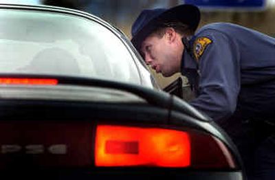 
Trooper Travis Robbins, of the Washington State Patrol, talks to a driver about speeding through the eastbound side of the construction zone on Interstate 90 Friday afternoon. The driver wasn't ticketed.  
 (Brian Plonka / The Spokesman-Review)