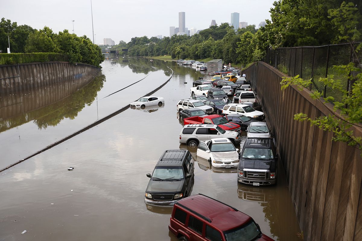 Cars and motorists sit stranded along I-45 in Houston after storms flooded the area Tuesday. (Associated Press)