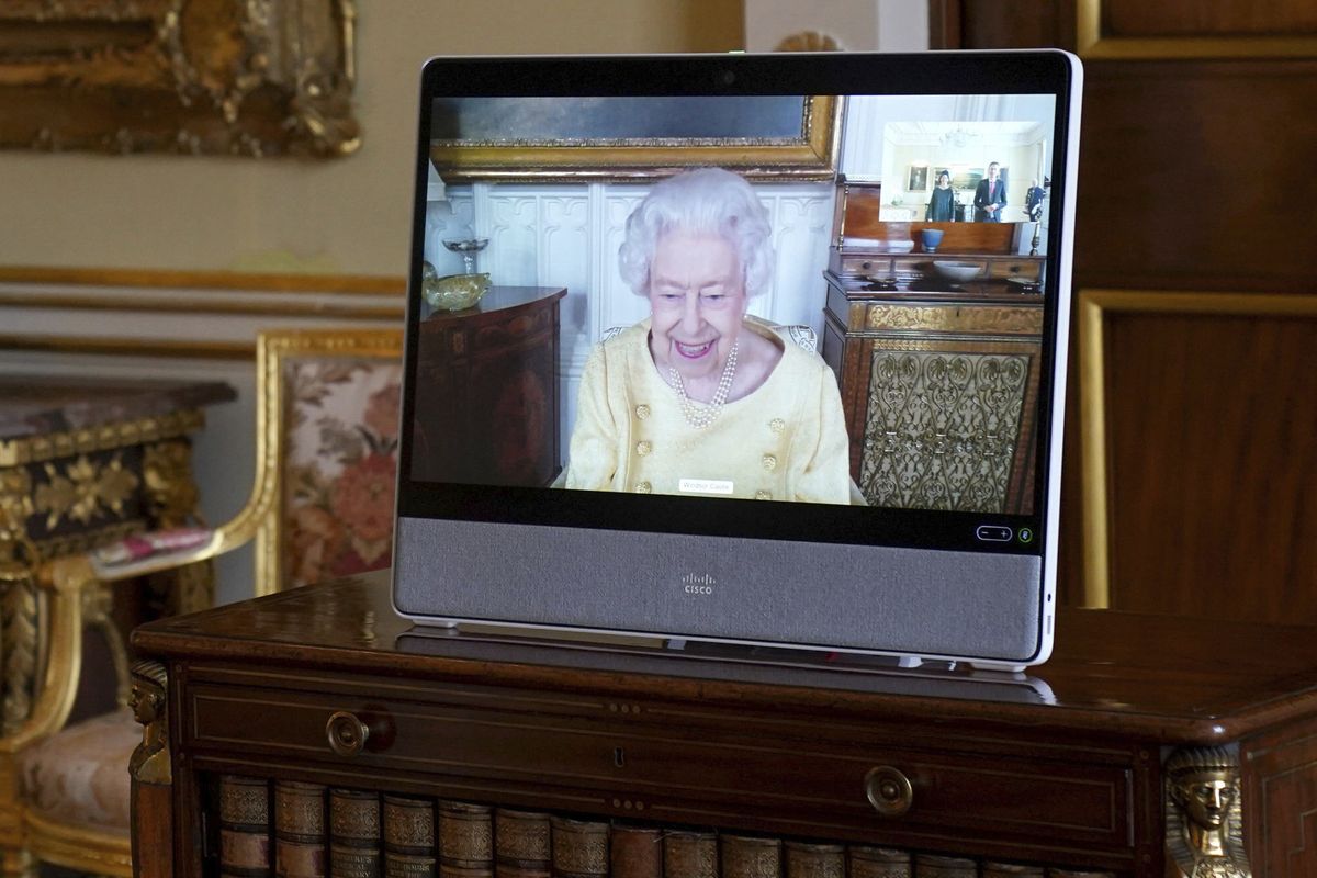 Queen Elizabeth II appears on a screen via videolink from Windsor Castle, where she is in residence, during a virtual audience at Buckingham Palace, London, Tuesday, Oct. 26, 2021.  (Victoria Jones)