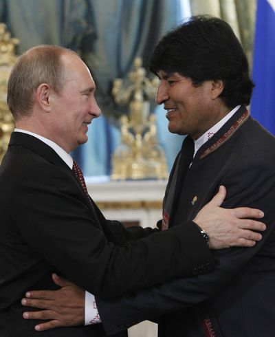 Russian President Vladimir Putin, left, greets Bolivia’s President Evo Morales in Moscow on Tuesday. (Associated Press)