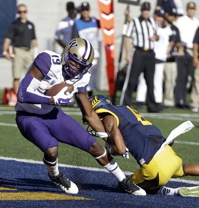 Washington's DiAndre Campbell (19) scores past California's Darius White during the first half of the Huskies’ 31-7 win over the Bears. (Associated Press)