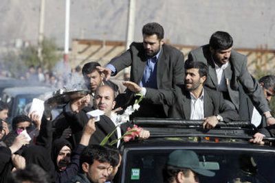 
Iran's President Mahmoud Ahamadinejad, second from right, greets supporters Wednesday. Ahmadinejad said Wednesday that Iran has made a decision to pursue a peaceful nuclear program. 
 (Associated Press / The Spokesman-Review)