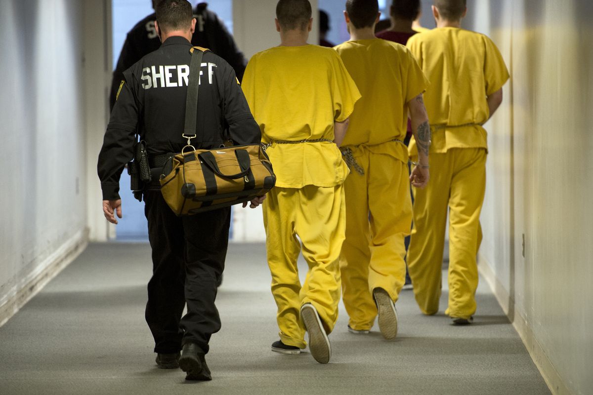 Deputies escort inmates through the corridors of the Spokane County Jail on Tuesday. (Dan Pelle)