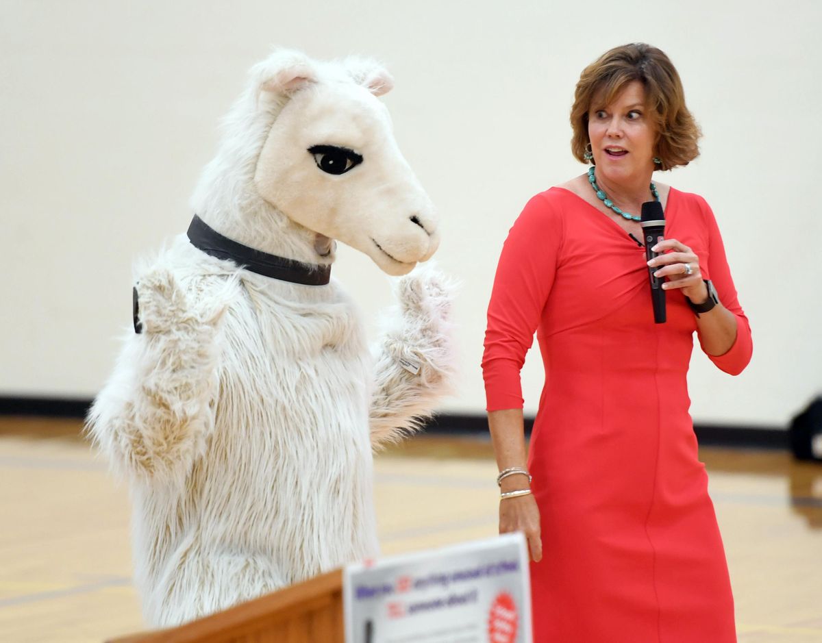 During a talk about campus safety for students at Borah Elementary in Coeur d’Alene, Idaho First Lady Lori Otter acts surprised as a llama sneaks up behind her Wednesday during a school assembly. The llama, played by the school counselor, was an analogy about when kids see something out of place in school, they should tell an adult right away. Otter introduced the “See, Tell, Now” campaign and encouraged the kids to be the eyes and ears of school security. (Jesse Tinsley / The Spokesman-Review)