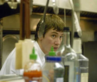 
Executive chef Mike Thornton oversees the kitchen at Mirabeau Park Hotel. He helped 47 food and beverage workers prepare and serve meals for four banquets, more than  350 people, and the regular dinner crowd  Dec. 13.
 (Photosby J. BART RAYNIAK / The Spokesman-Review)