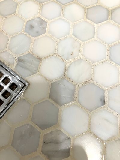 If you look closely, you’ll see flecks of dirt. Cleaning grout between hexagonal tiles is a challenge.  (Tribune Content Agency)