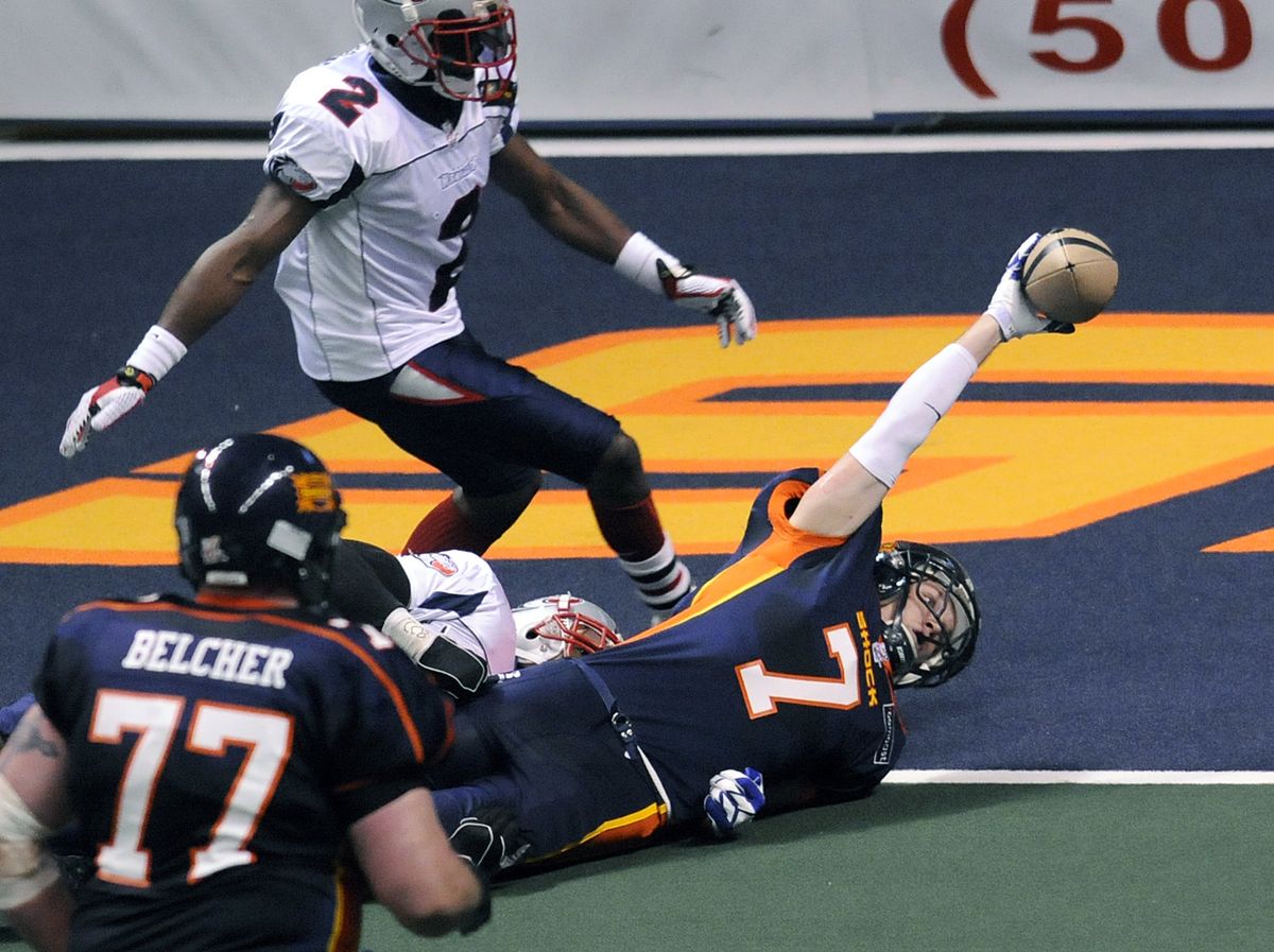 Spokane’s Andy Olson reaches over the goal line for a touchdown as Austin’s Ricky Williams closes in Saturday at the Arena.  (Dan Pelle / The Spokesman-Review)