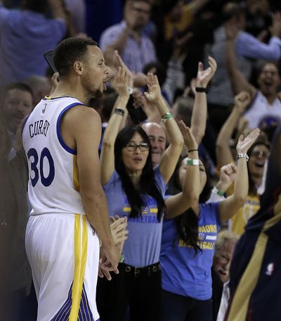 Golden State Warriors’ Stephen Curry celebrates a score against the New Orleans Pelicans during the Warriors’ 116-106 win on Monday in Oakland, California. Curry broke the NBA single-game 3-point record with 13. (Ben Margot / Associated Press)
