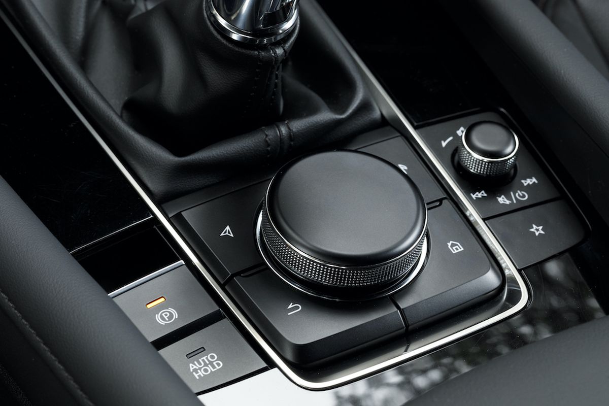 The  Mazda3 infotainment system is controlled with a console-mounted knob supported by hard buttons on the console and the steering wheel. (Mazda)
