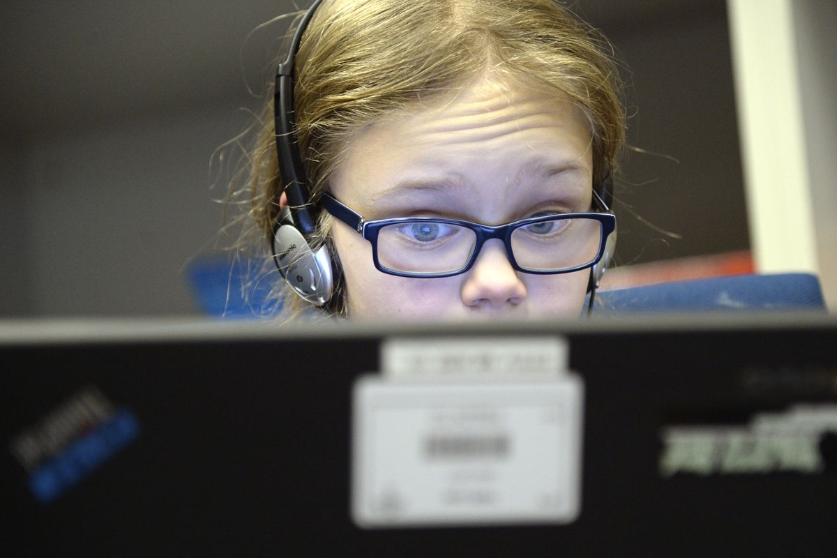 Faith White, 10, concentrates on mixing digital music files during a Tuesday meeting of the Electronic Music Club. (Jesse Tinsley)