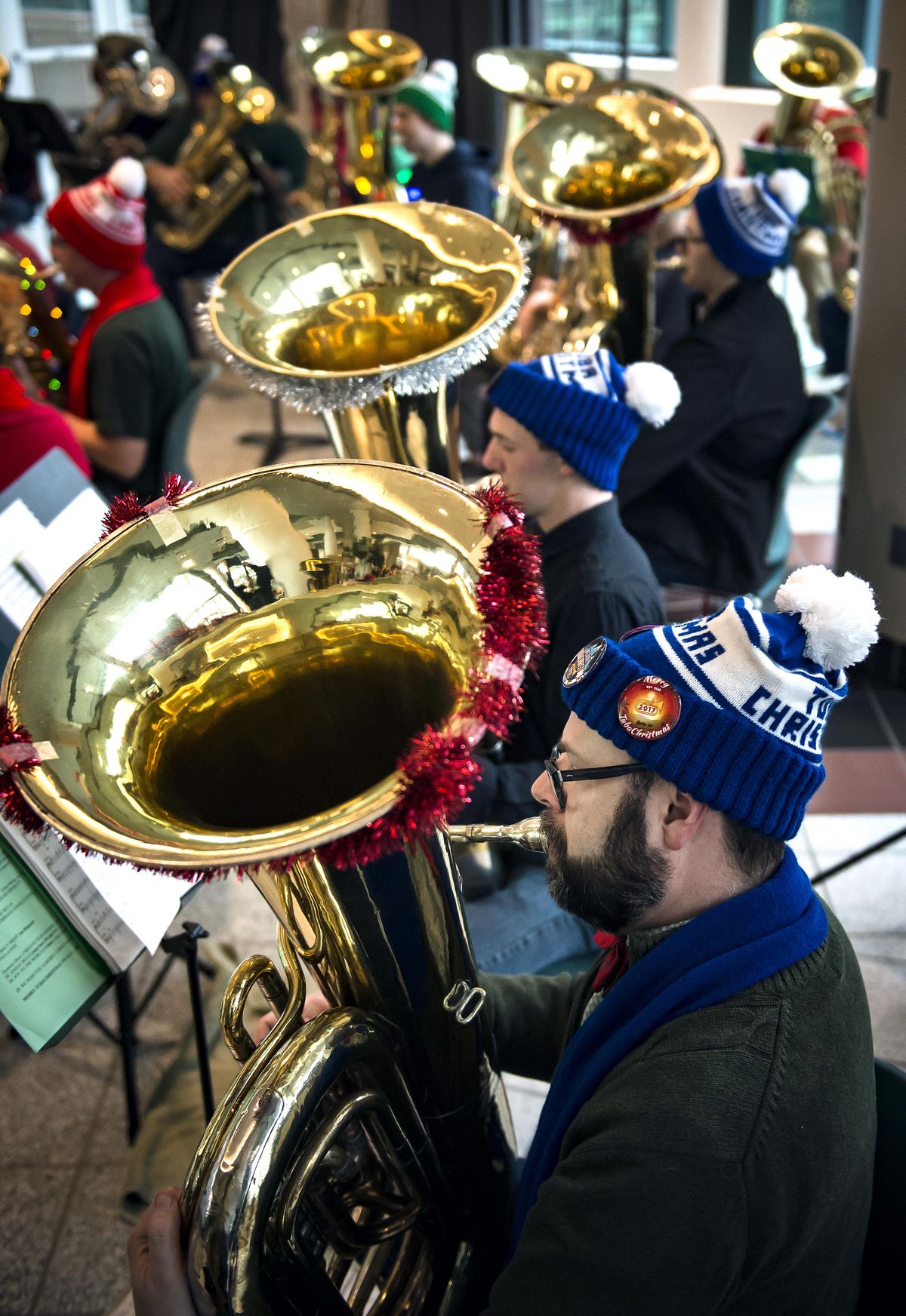Jim Windisch, of Coeur dAlene, plays Christmas songs on his bass tuba during the Spokane TubaChristmas concert held Sat., Dec.9, 2017, in the STA Plaza. The concert, conducted by Vern Windham, featured over 40 tuba and euphonium players. (Colin Mulvany / The Spokesman-Review)