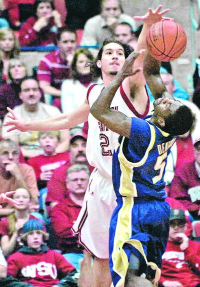 
Washington's State's Derrick Low blocks Washington's Justin Dentmon during the first half of Saturday's game. 
 (Jed Conklin / The Spokesman-Review)