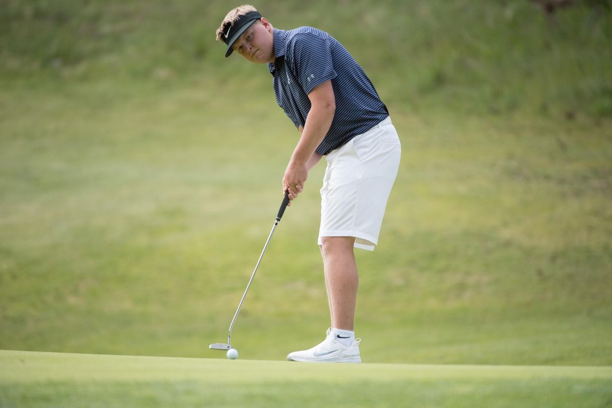Gonzaga Prep’s Nate Plaster putts on the 18th hole during the State 4A boys golf tournament on Wednesday  at the Creek at Qualchan Golf Course in Spokane. (Tyler Tjomsland / The Spokesman-Review)
