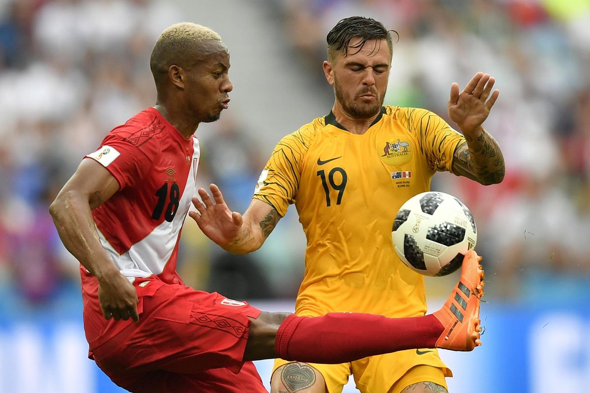 Peru’s Andre Carrillo, left, and Australia’s Joshua Risdon challenge for the ball during the Group C match between Australia and Peru, at the 2018 soccer World Cup in the Fisht Stadium in Sochi, Russia, Tuesday, June 26, 2018. (Martin Meissner / Associated Press)