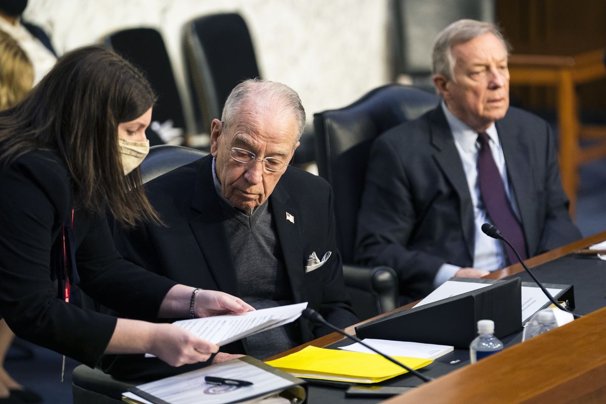 Senate Judiciary Committee ranking member Sen. Chuck Grassley, R-Iowa, center, with committee Chairman Sen. Dick Durbin, D-Ill., confers with a staff during a committee hearing to examine the domestic terrorism threat one year after January 6, on Capitol Hill, Thursday, Feb. 10, 2022, in Washington.  (Manuel Balce Ceneta)