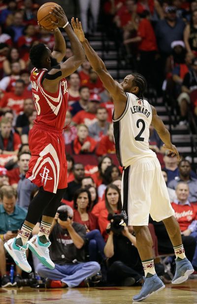 Houston Rockets guard James Harden (13) shoots over San Antonio Spurs forward Kawhi Leonard (2) in the second half of game Friday.