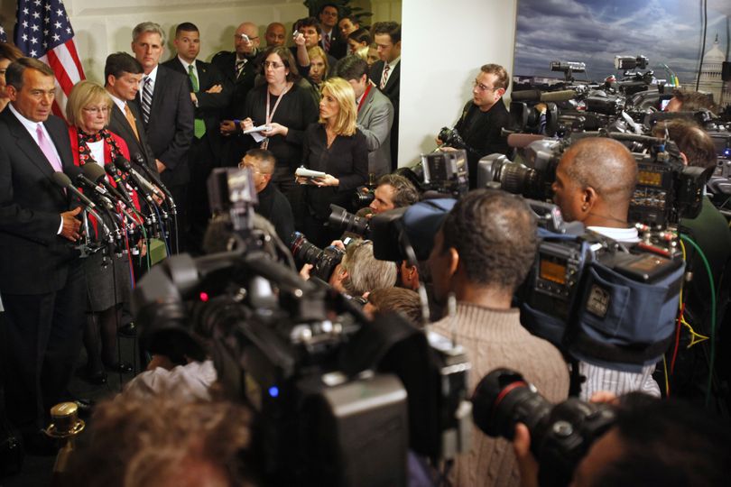 Surrounded by news media, House Speaker John Boehner, of Ohio, far left, announces that an agreement to avert a government shutdown was reached at the U.S. Capitol in Washington, on Friday, April 8, 2011. (Jacquelyn Martin / Associated Press)