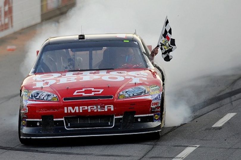 Tony Stewart celebrates his third win of the season, taking the checkered flag after the NASCAR Sprint Cup Series TUMS Fast Relief 500 at Martinsville Speedway on Sunday. Photo Credit: John Harrelson/Getty Images for NASCAR (John Harrelson / Getty Images North America)