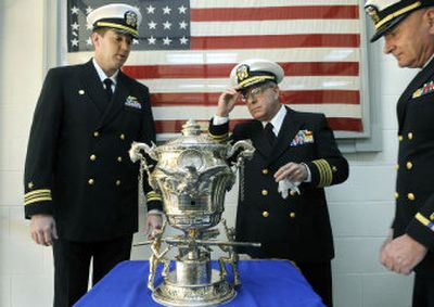
Cmdr. Paul Darling, Capt. Joseph B. Green and Bruce Rasche CWO4 USN (Ret) view the 100 year-old Spokane Naval Trophy on display at the Navy Operational Support Center in Spokane.
 (Dan Pelle / The Spokesman-Review)