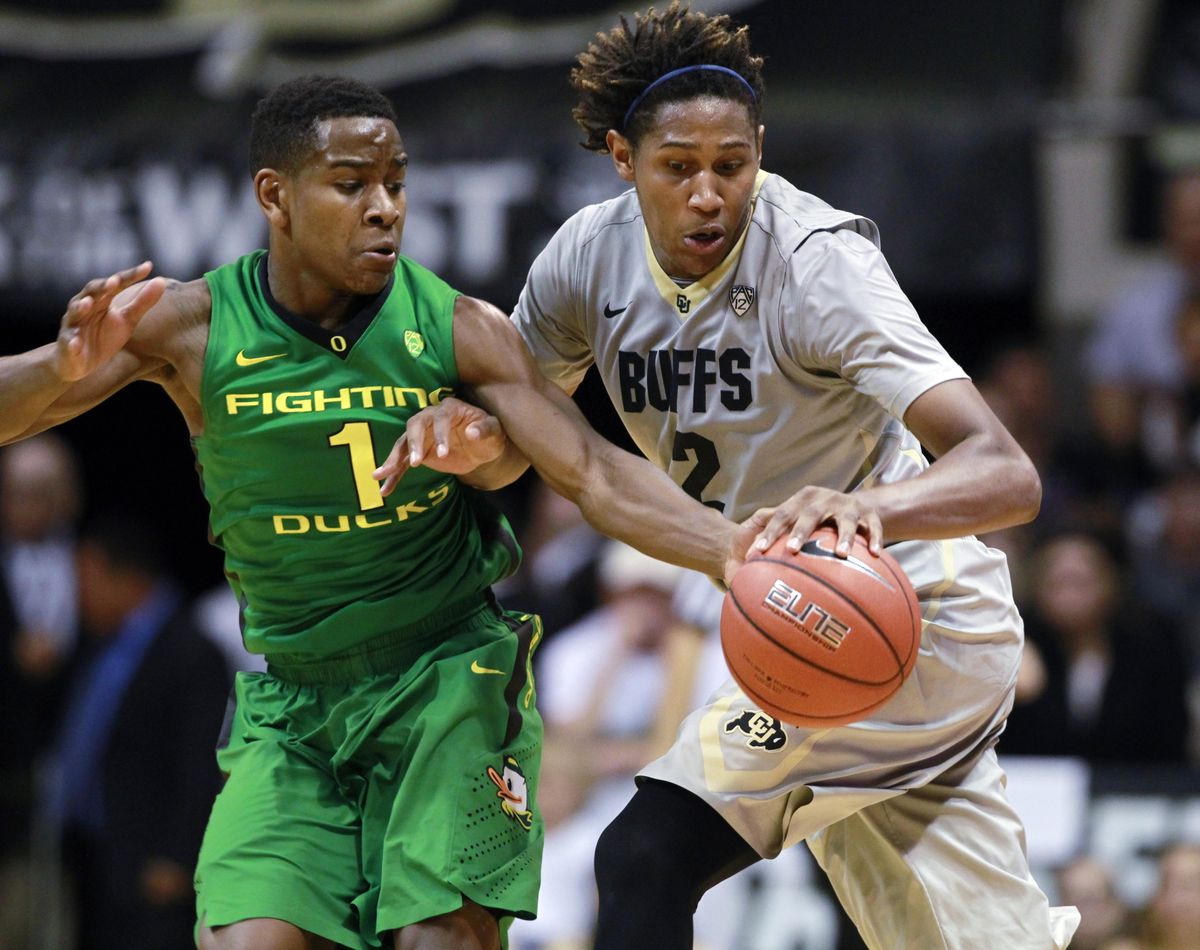 Oregon guard Dominic Artis tries to steal the ball from Colorado guard Xavier Johnson in the second half of Sunday’s game. (Associated Press)