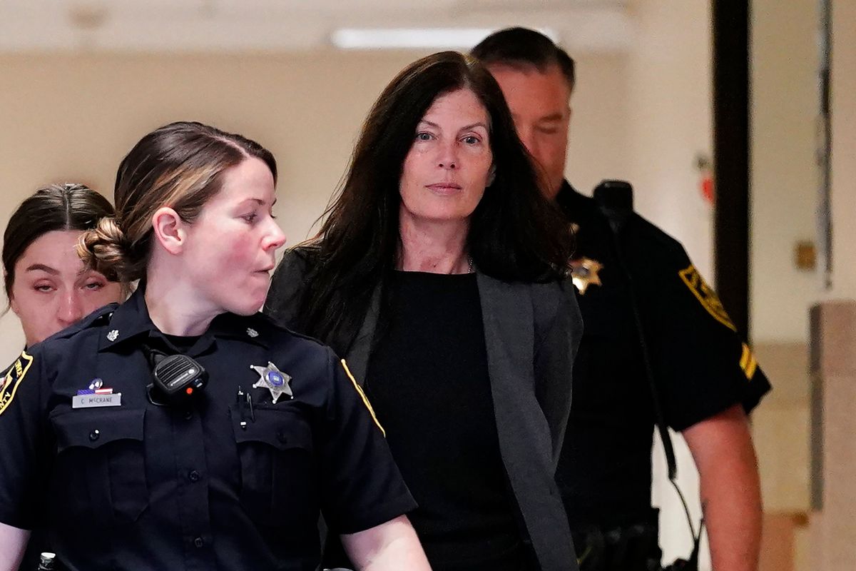 Former Pennsylvania Attorney General Kathleen Kane, center, is led to court as she arrives for a hearing on an alleged probation violation, at the Montgomery County Courthouse in Norristown, Pa., Monday, May 23, 2022. Pennsylvania