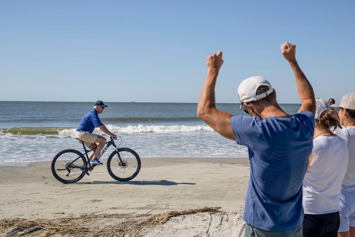President Joe Biden rides a bicycle on the beach at Kiawah Island, S.C., on Aug. 14.  (HAIYUN JIANG)