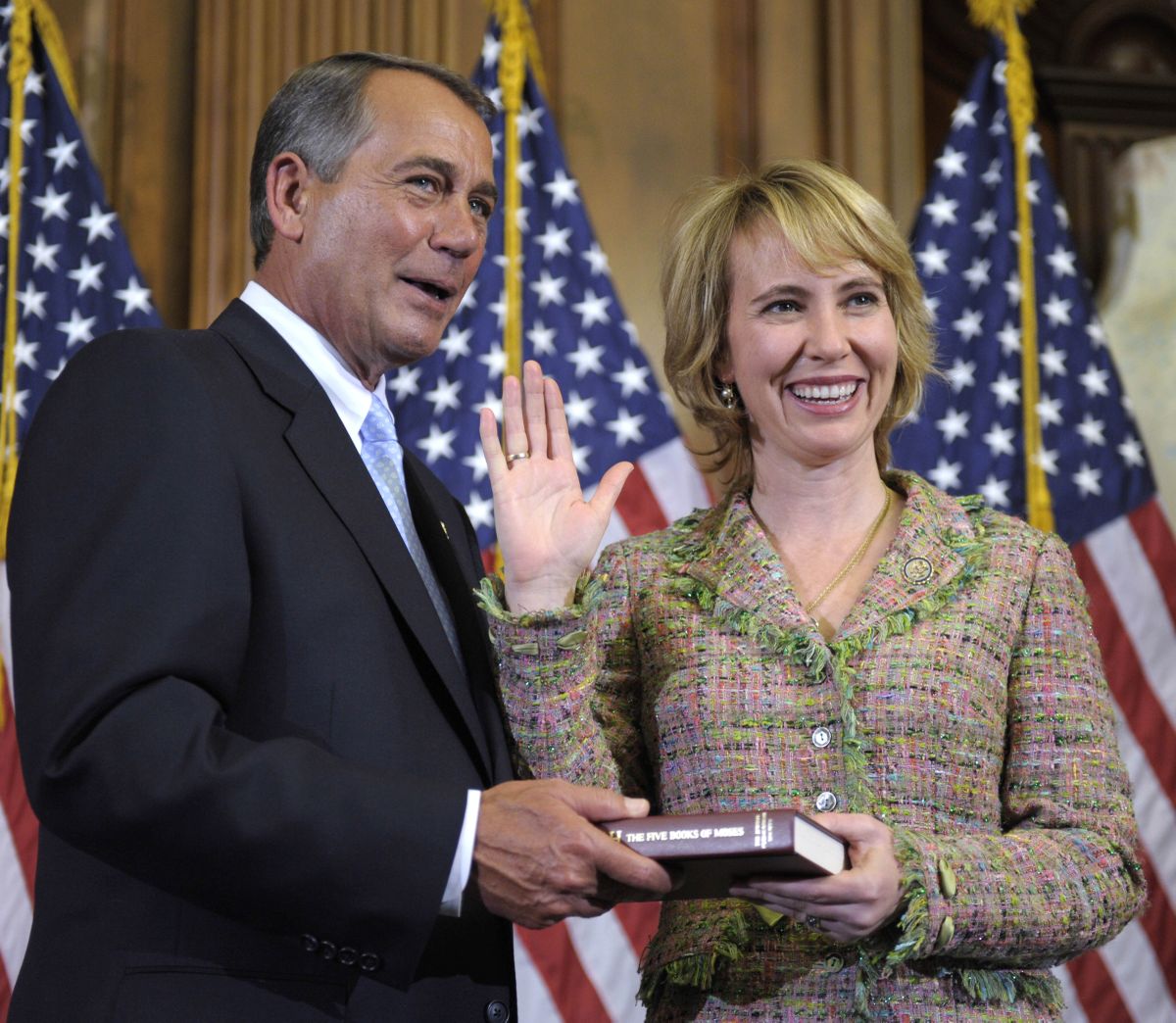 In this Jan. 5, 2011 file photo, House Speaker John Boehner reenacts the swearing in of Rep. Gabrielle Giffords, D-Ariz., on Capitol Hill in Washington. Authorities say that Giffords was shot in the head on Saturday, Jan. 8, 2011 while meeting with constituents in her district in the area around Tucson. (Susan Walsh / Associated Press)