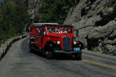 
Vintage red 1930s touring cars still travel Going-to-the-Sun Road.
 (The Spokesman-Review)