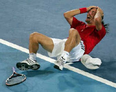 
Nicolas Massu of Chile reacts after winning the tennis men's gold medal singles match over American Mardy Fish 6-3, 3-6, 2-6, 6-3, 6-4.
 (Associated Press / The Spokesman-Review)