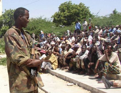 
An Ethiopian soldier stands guard as Somalis listen to the Transitional Federal Government prime minister, Ali Mohamed Gedi, in Mogadishu on Friday. 
 (Associated Press / The Spokesman-Review)