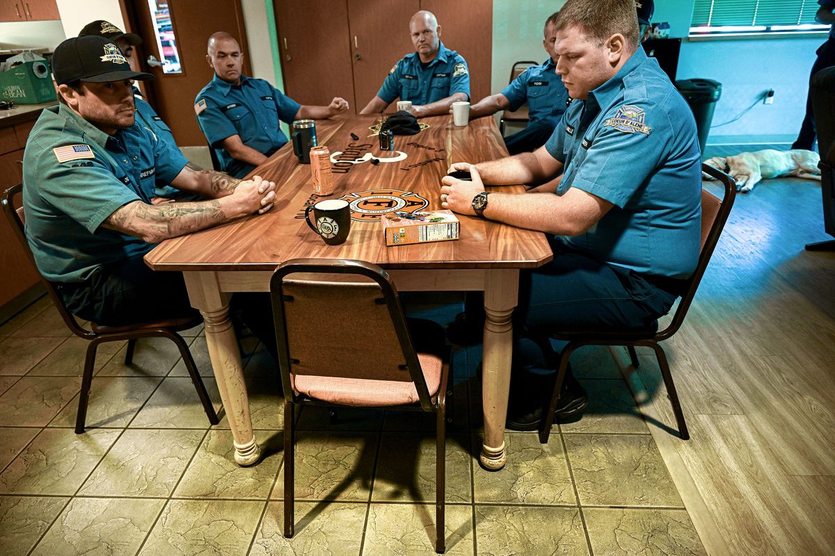 A group of Coeur d’Alene firefighters gathers Thursday to talk about Coeur d’Alene Fire Battalion Chief John Morrison as the empty chair at the head of the table belonged to him. Morrison was shot and killed last Sunday as he was responding to a brushfire in Coeur d’Alene. (Kathy Plonka/The Spokesman-Review)