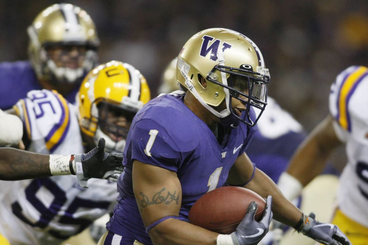 Washington’s Chris Polk carried 21 times for 90 yards but also had a critical fumble in the Huskies’ loss to LSU. (Associated Press / The Spokesman-Review)