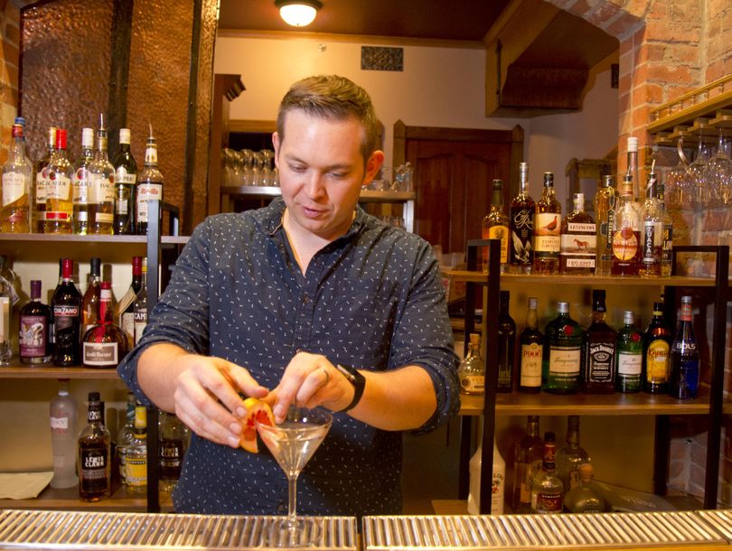 Busy restaurateur Adam Hegsted mixes a cocktail in his newest restaurant, the Gilded Unicorn, set to open in early December in the former Catacombs underground space on South Monroe Street in downtown Spokane on Tuesday, Nov. 17, 2015. (Jesse Tinsley / The Spokesman-Review)