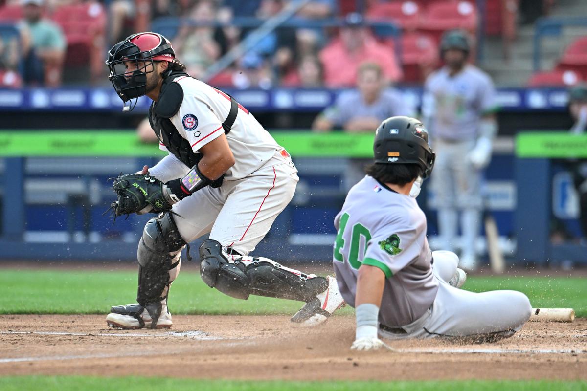 Eugene Emeralds catcher Daniel Rogers slides ahead of a tag from Spokane Indians catcher Alan Espinal in the second inning on Aug. 4, 2026 at Avista Stadium.  (James Snook)