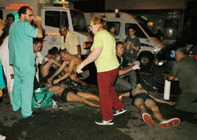 
People injured in a nightclub fire are treated outside the club in Buenos Aires, Argentina, early today. 
 (Associated Press / The Spokesman-Review)