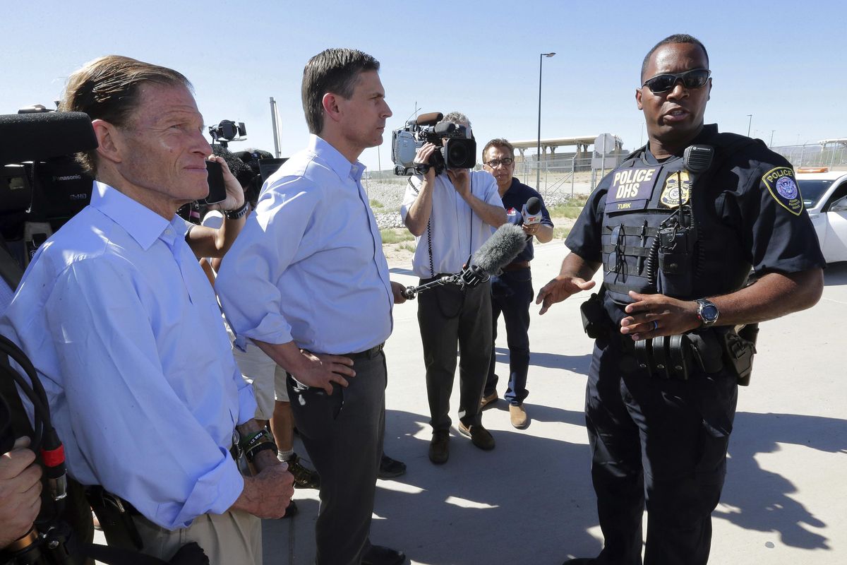 U.S. Sen. Martin Heinrich, D-N.M., center, and U.S. Sen. Richard Blumenthal, D-Ct., left, speak with a Dept. of Homeland Security agent as they arrive to tour the Fabens Port-of-Entry facility which houses tent shelters used to hold separated family members, Friday, June 22, 2018, in Fabens, Texas. (Matt York / Associated Press)