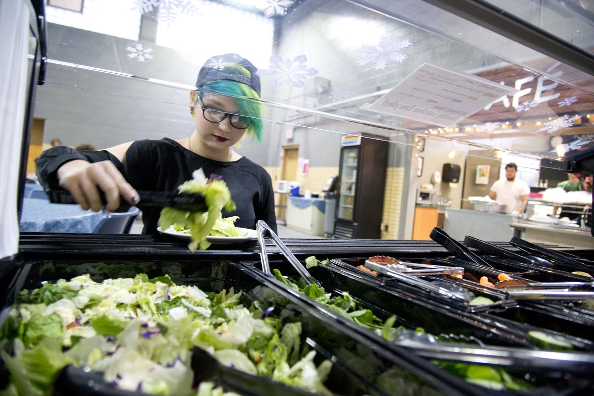 Robyn Hopkins, a sophomore at the Community School, loads her plate from the salad bar in the school’s lunchroom on Friday. (Jesse Tinsley)