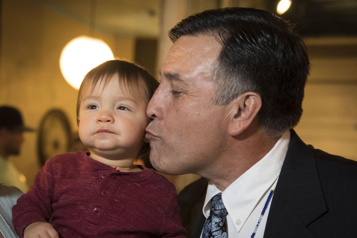 Candidate for the U.S. 5th District Rep. Joe Pakootas, D, kisses his grandson Fyball Peone, 11 months, during his election night party at Stellas Cafe and Bar, Tues. Nov. 8, 2016. (Colin Mulvany / The Spokesman-Review)