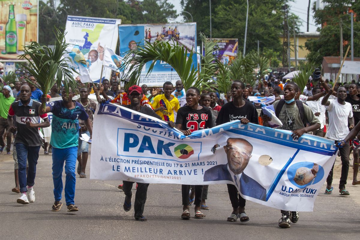 In this Friday March 19, 2021 photo, supporters of opposition presidential candidate Guy Brice Parfait Kolelas cheer during their party